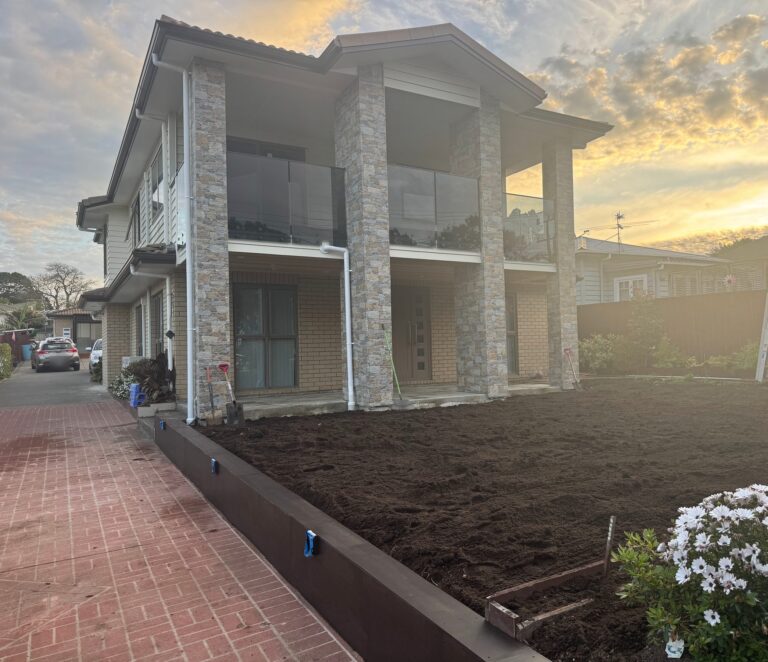Completed two-storey home at 69 Margan Ave, New Lynn, with stone-clad columns and a new front garden